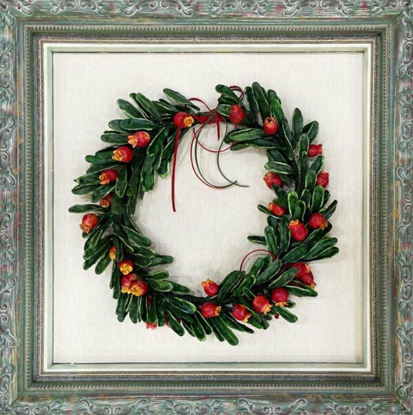 Pomegranate wreath in a frame