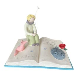 The Little Prince with the Fox and Rose on a book